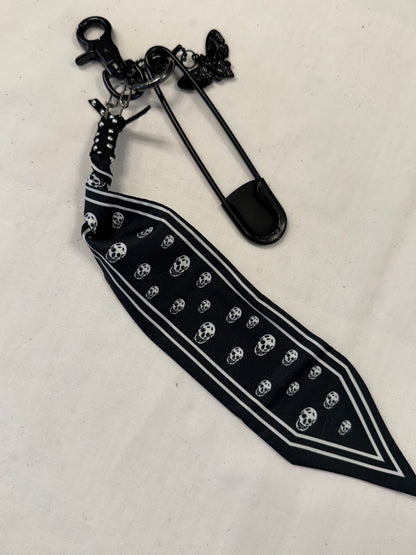 Bag Charm Cluster on Black Hardware with a Skull Scarf, XL Black Safety Pin, and Skull Moth Charm