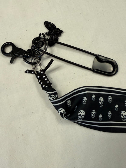 Bag Charm Cluster on Black Hardware with a Skull Scarf, XL Black Safety Pin, and Skull Moth Charm