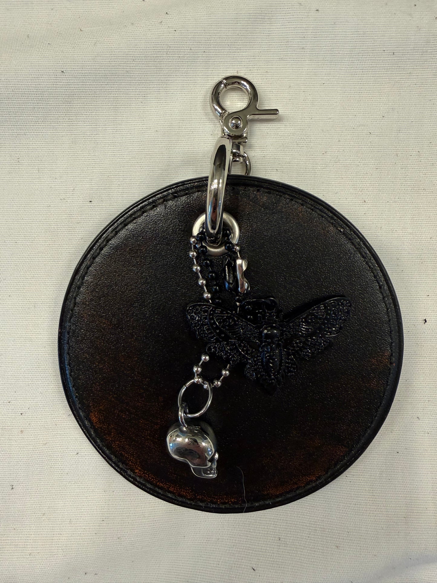 Repurposed Coach Coaster Bag Charm with Skull and Moth Charms