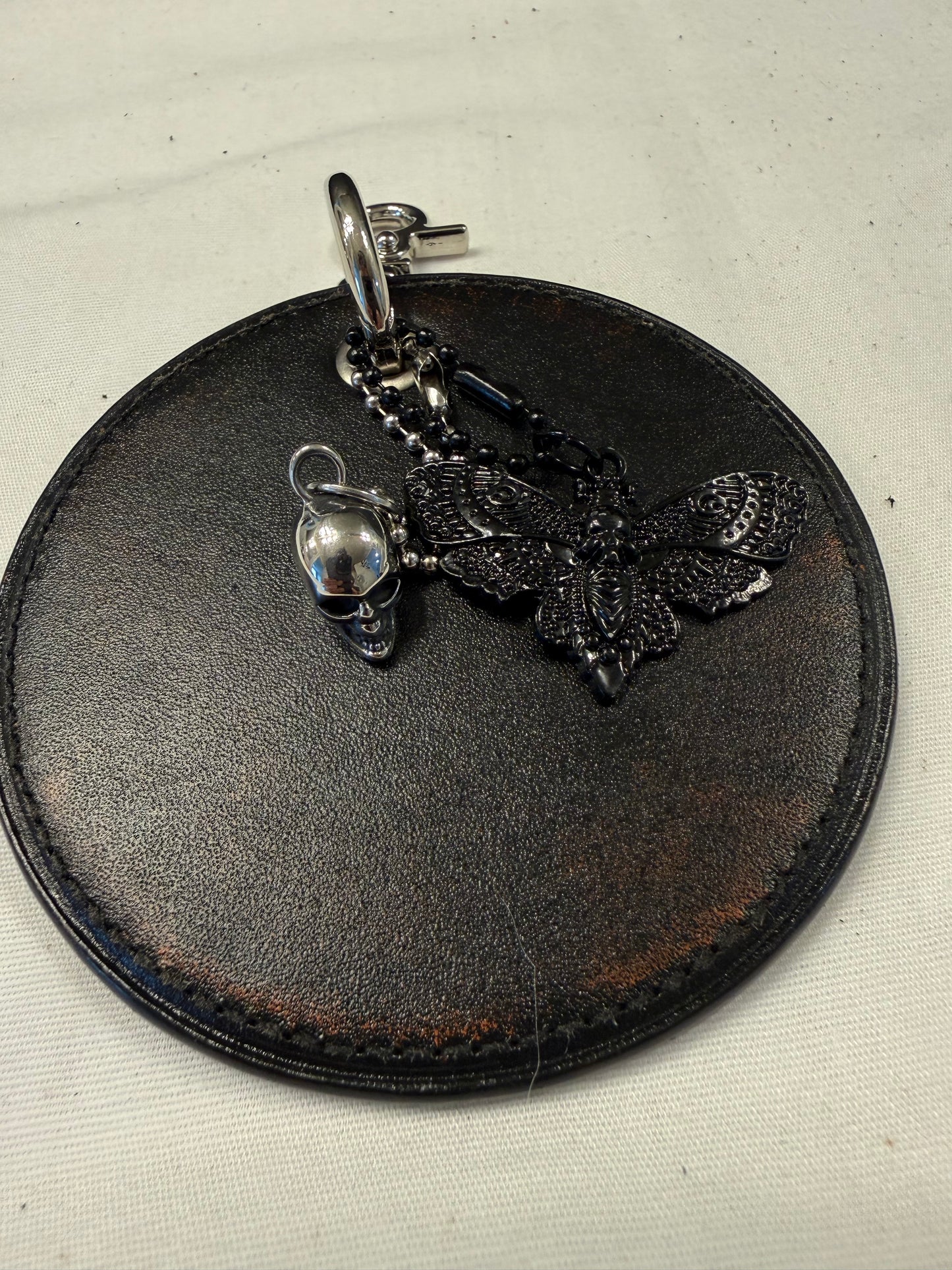 Repurposed Coach Coaster Bag Charm with Skull and Moth Charms