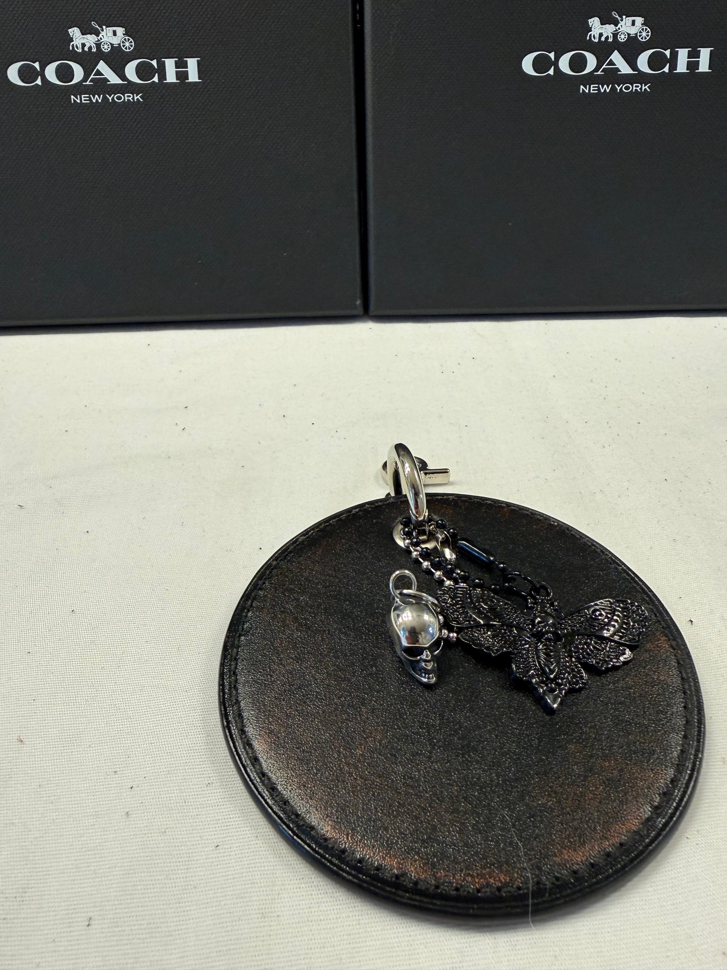 Repurposed Coach Coaster Bag Charm with Skull and Moth Charms