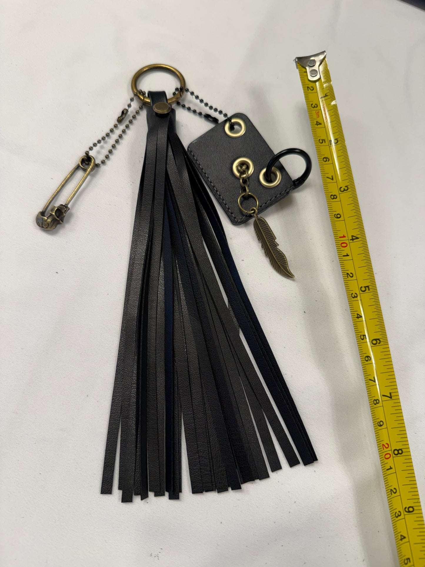 Vegan Leather Handmade Tassel with Repurposed Coach Tic Tac Toe Piece Riveted Charm and Skull Safety Pin Antique Brass Bag Charm
