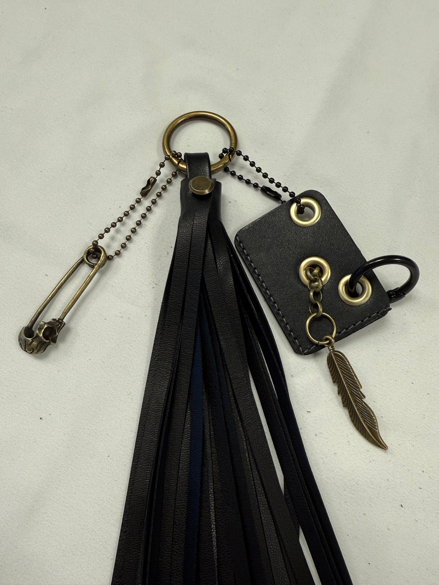 Vegan Leather Handmade Tassel with Repurposed Coach Tic Tac Toe Piece Riveted Charm and Skull Safety Pin Antique Brass Bag Charm