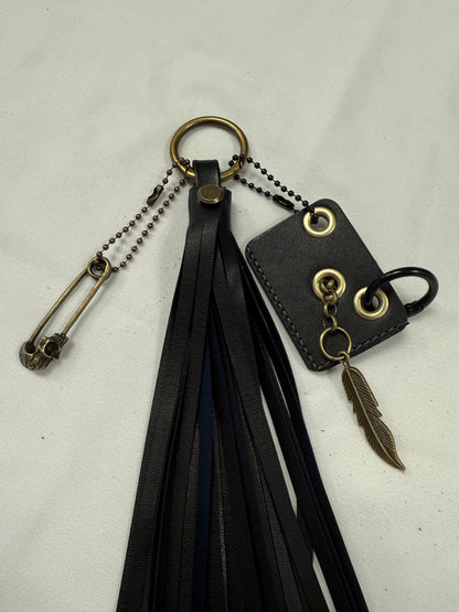 Vegan Leather Handmade Tassel with Repurposed Coach Tic Tac Toe Piece Riveted Charm and Skull Safety Pin Antique Brass Bag Charm