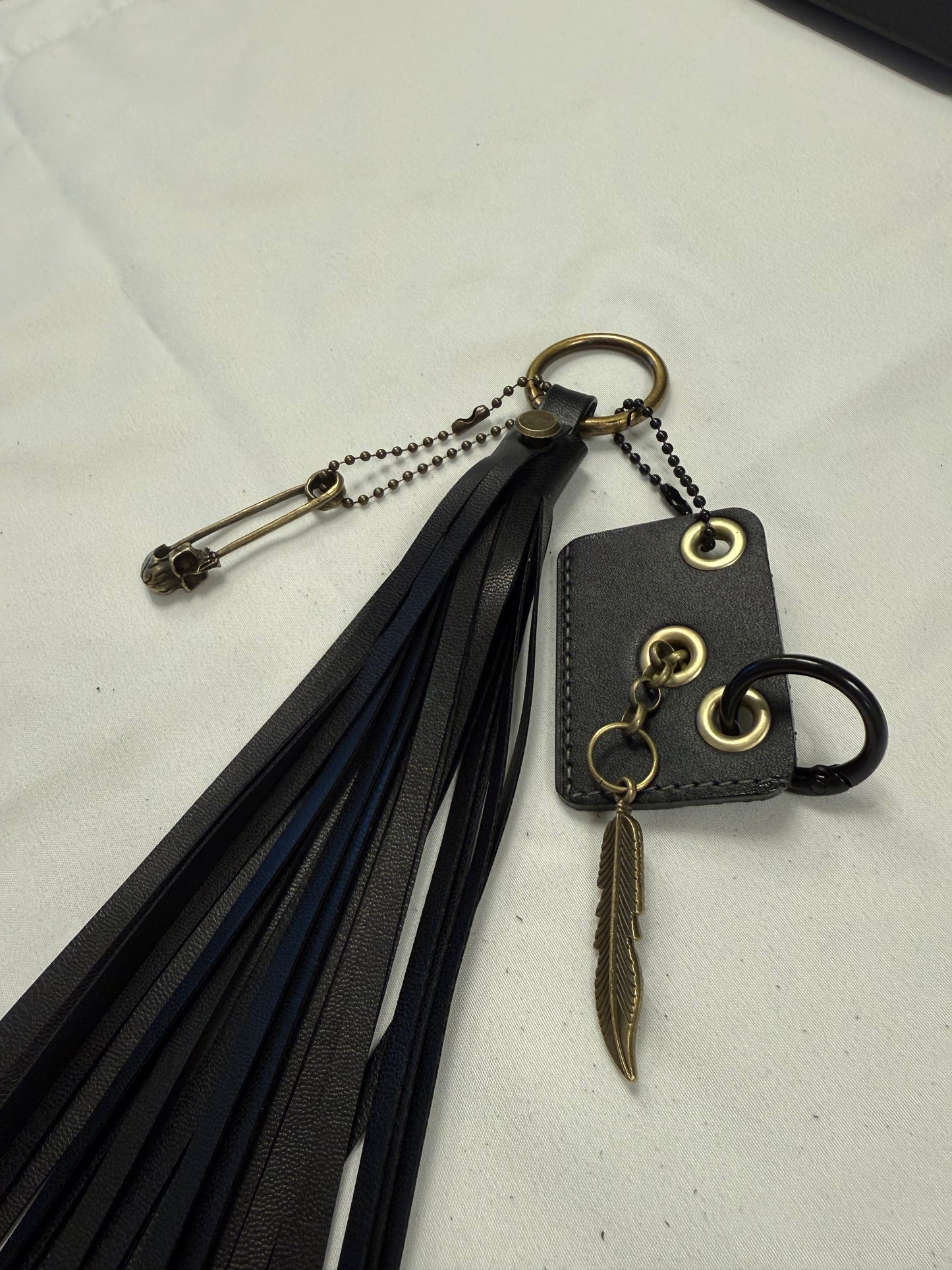 Vegan Leather Handmade Tassel with Repurposed Coach Tic Tac Toe Piece Riveted Charm and Skull Safety Pin Antique Brass Bag Charm