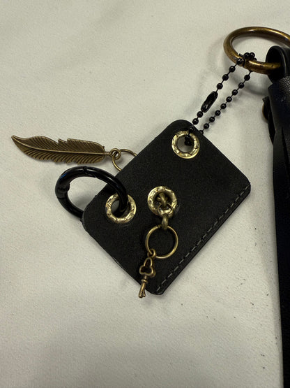 Vegan Leather Handmade Tassel with Repurposed Coach Tic Tac Toe Piece Riveted Charm and Skull Safety Pin Antique Brass Bag Charm
