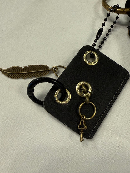 Vegan Leather Handmade Tassel with Repurposed Coach Tic Tac Toe Piece Riveted Charm and Skull Safety Pin Antique Brass Bag Charm