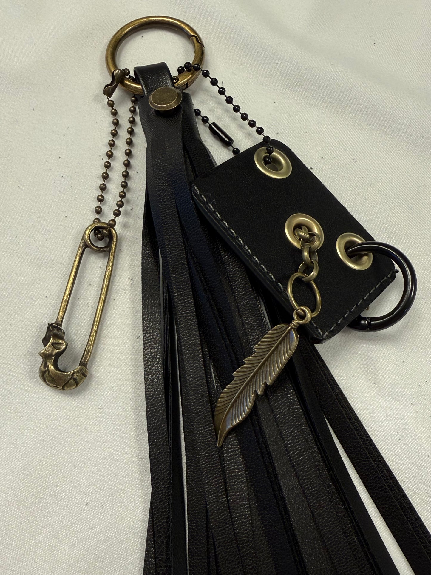 Vegan Leather Handmade Tassel with Repurposed Coach Tic Tac Toe Piece Riveted Charm and Skull Safety Pin Antique Brass Bag Charm