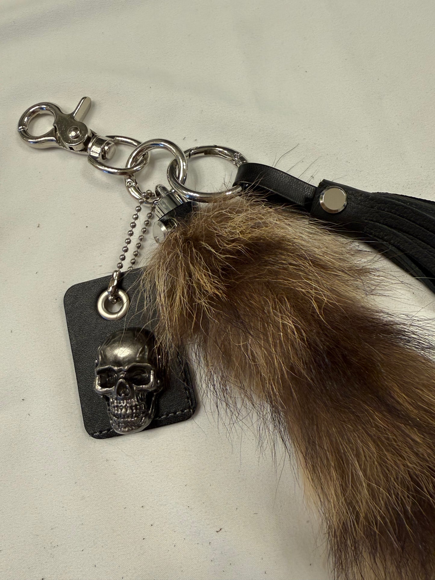 Faux Raccoon Tail, Leather Tassel, and Repurposed Coach Tic Tac Toe Piece Bag Charm Cluster