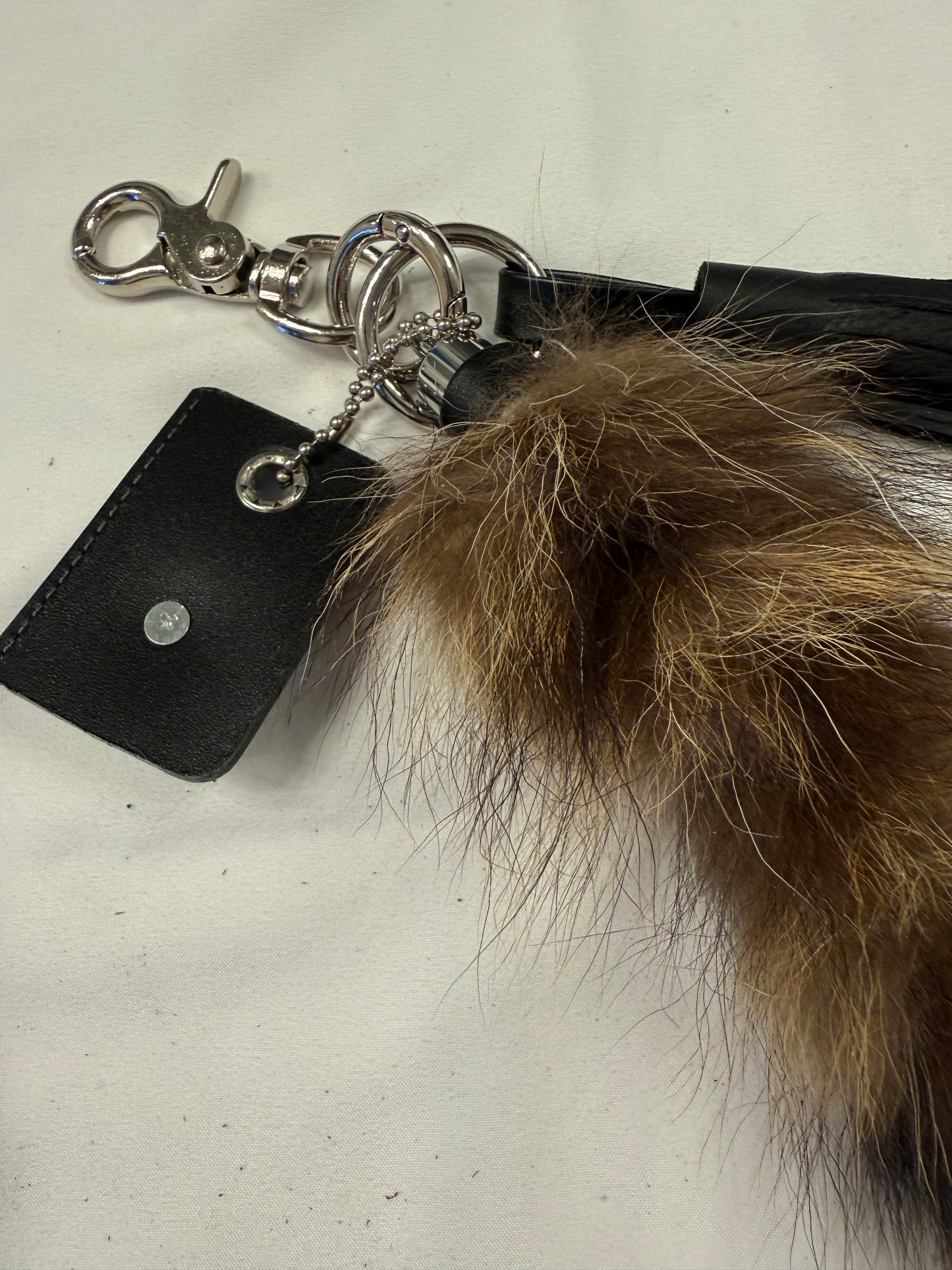 Faux Raccoon Tail, Leather Tassel, and Repurposed Coach Tic Tac Toe Piece Bag Charm Cluster