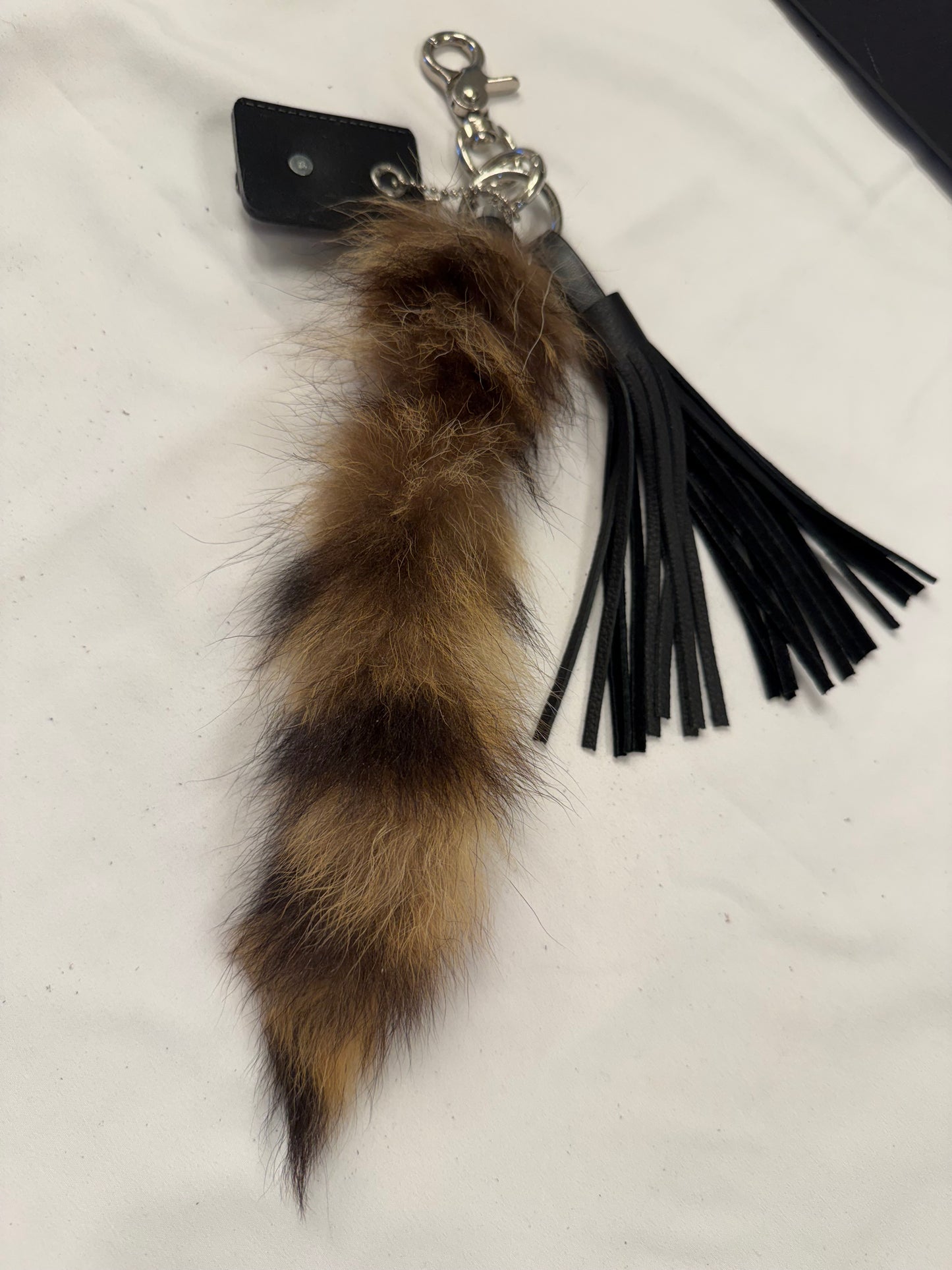Faux Raccoon Tail, Leather Tassel, and Repurposed Coach Tic Tac Toe Piece Bag Charm Cluster