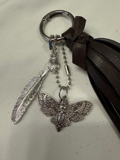 Vegan Leather Handmade Tassel in Dark Maple with Silver Tone Hardware Feather and Skull Moth Bag Charm