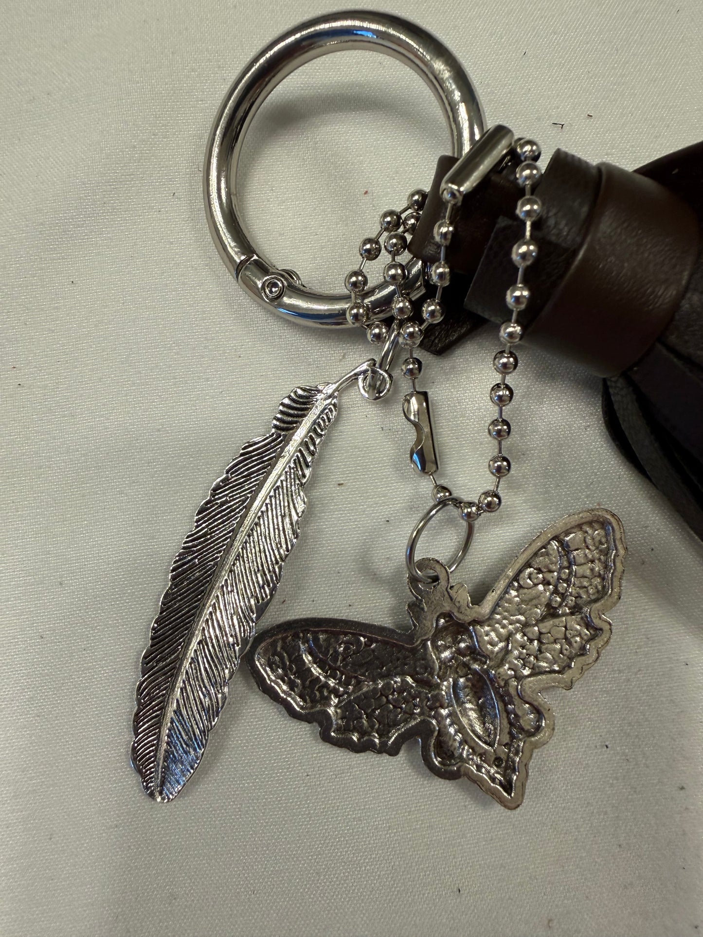 Vegan Leather Handmade Tassel in Dark Maple with Silver Tone Hardware Feather and Skull Moth Bag Charm