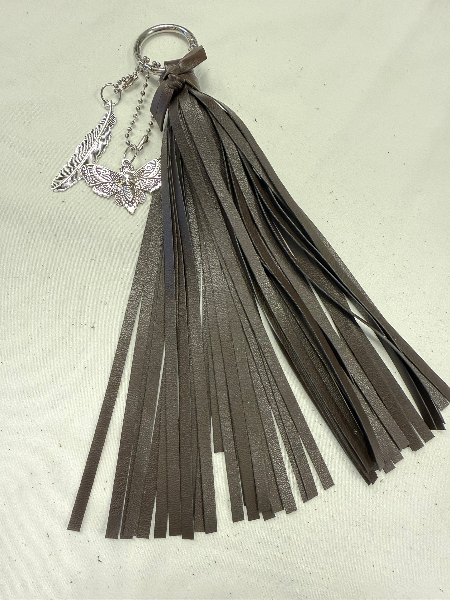Vegan Leather Handmade Tassel in Dark Maple with Silver Tone Hardware Feather and Skull Moth Bag Charm