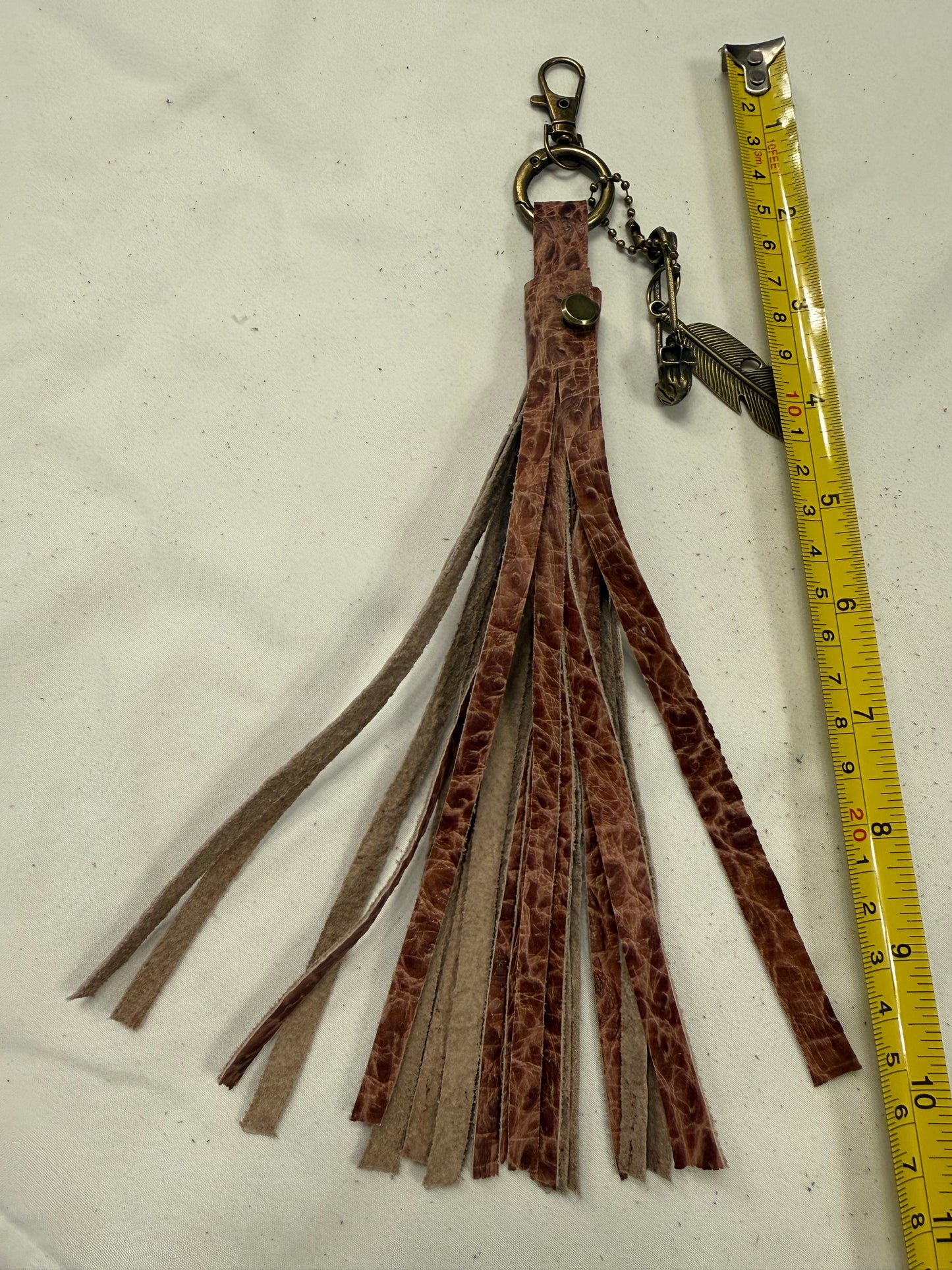 Hand cut Leather Brown Embossed Tassel with Skull Safety Pin and Feather Charm